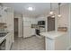 Well-lit kitchen with white appliances and adjacent dining space at 311 Thornberry Dr, Carmel, IN 46032