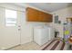 Bright laundry room with washer, dryer, and cabinets for storage at 311 Thornberry Dr, Carmel, IN 46032