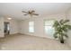 Bright living room featuring neutral walls, carpet, a ceiling fan, and natural light at 311 Thornberry Dr, Carmel, IN 46032
