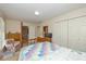 Comfortable main bedroom featuring a four-poster bed, soft lighting, and closet at 311 Thornberry Dr, Carmel, IN 46032