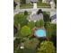 Overhead shot of backyard pool, deck, trees, and adjacent homes in a residential area at 318 Meadowview Ln, Greenwood, IN 46142