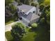 Aerial view of brick home with large three-car garage, mature trees, and landscaping at 318 Meadowview Ln, Greenwood, IN 46142