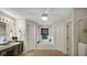 Bathroom featuring a soaking tub, natural light, dual sinks, and three doors to the en suite at 318 Meadowview Ln, Greenwood, IN 46142