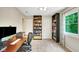 A spacious room featuring a desk, two doors, and built-in bookshelves for storage at 318 Meadowview Ln, Greenwood, IN 46142