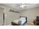 Neutrally decorated bedroom with floating shelf and ceiling fan at 318 Meadowview Ln, Greenwood, IN 46142