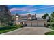 Charming two-story home at twilight with a three-car garage and landscaped yard at 318 Meadowview Ln, Greenwood, IN 46142