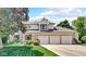 Charming two-story home with brick facade, manicured lawn, and a spacious three-car garage at 318 Meadowview Ln, Greenwood, IN 46142