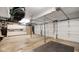 Large garage with multiple overhead doors, cabinets, and space for storage at 318 Meadowview Ln, Greenwood, IN 46142