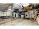 Spacious garage with ample storage cabinets, refrigerator, and organized shelves at 318 Meadowview Ln, Greenwood, IN 46142