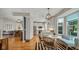Bright kitchen boasts stainless steel appliances, white cabinets, and an eat-in area at 318 Meadowview Ln, Greenwood, IN 46142