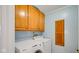 Laundry room featuring washer and dryer units with wood cabinets above at 318 Meadowview Ln, Greenwood, IN 46142