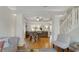 Open-concept living and dining area with hardwood floors and a view of the staircase at 318 Meadowview Ln, Greenwood, IN 46142