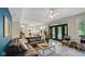 Open-concept living room with a modern kitchen, patio, and a black sectional sofa at 318 Meadowview Ln, Greenwood, IN 46142