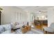 Open-concept living area showcasing hardwood floors, stylish furniture, and seamless flow to the dining area at 318 Meadowview Ln, Greenwood, IN 46142
