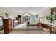 Bright main bedroom features vaulted ceilings, a ceiling fan, and a separate elevated office space at 318 Meadowview Ln, Greenwood, IN 46142