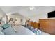 Bright main bedroom features vaulted ceilings, and classic wooden furniture at 318 Meadowview Ln, Greenwood, IN 46142