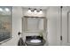 Stylish powder room with a granite countertop and decorative mirror at 318 Meadowview Ln, Greenwood, IN 46142