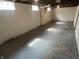 Spacious unfinished basement with concrete walls and floors, offering potential for customization at 330 S Butler Ave, Indianapolis, IN 46219