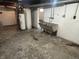 Basement with laundry tub in a large open space with concrete walls and floors, utility ready at 330 S Butler Ave, Indianapolis, IN 46219