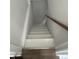 Basement stairway leading to finished basement with white paint and wood hand rail at 330 S Butler Ave, Indianapolis, IN 46219