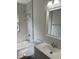 Bathroom featuring a modern vanity with chrome fixtures and a shower/tub combo with marble tile at 330 S Butler Ave, Indianapolis, IN 46219