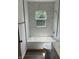 Updated bathroom featuring a tub and shower combination with a marble tile surround at 330 S Butler Ave, Indianapolis, IN 46219