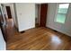 A bright bedroom featuring original hardwood floors and a window at 330 S Butler Ave, Indianapolis, IN 46219