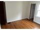 Bright bedroom featuring hardwood floors and neutral walls, offering a serene and inviting atmosphere at 330 S Butler Ave, Indianapolis, IN 46219