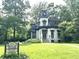 Beautiful two-story home with lush green lawn and mature trees at 330 S Butler Ave, Indianapolis, IN 46219