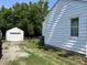 A house's white siding and window are visible, with a detached garage in the background at 330 S Butler Ave, Indianapolis, IN 46219