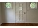 Close-up shot of a front door with a decorative window in the center at 330 S Butler Ave, Indianapolis, IN 46219