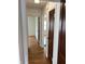A naturally lit hallway featuring hardwood floors and classic doors at 330 S Butler Ave, Indianapolis, IN 46219