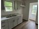 A charming kitchen featuring updated gray cabinets, a stainless steel sink, and modern countertops at 330 S Butler Ave, Indianapolis, IN 46219