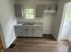 A charming kitchen featuring updated gray cabinets, a stainless steel sink, and modern countertops at 330 S Butler Ave, Indianapolis, IN 46219