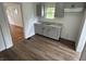 A charming kitchen featuring updated gray cabinets, a stainless steel sink, and modern countertops at 330 S Butler Ave, Indianapolis, IN 46219