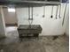 Utility sink in basement with plumbing hookups and concrete flooring at 330 S Butler Ave, Indianapolis, IN 46219
