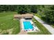 The backyard has a large in-ground pool with plenty of lounge space and an outdoor kitchen at 3325 Kivett Ln, Martinsville, IN 46151