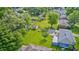 An aerial view of a green backyard featuring a small shed, a lush lawn, and mature trees bordering the property at 3414 Ferncliff Ave, Indianapolis, IN 46227