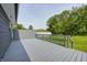 Backyard deck made of gray stained wood with a partial view of the fenced-in yard at 3414 Ferncliff Ave, Indianapolis, IN 46227