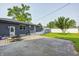 Back of house with dark siding, bright trim, and a small backyard seating area at 3414 Ferncliff Ave, Indianapolis, IN 46227
