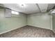 Unfinished basement area with vinyl flooring and wire rack shelving at 3414 Ferncliff Ave, Indianapolis, IN 46227