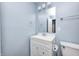 This bathroom features a white sink with storage and a mirror, and light blue walls at 3414 Ferncliff Ave, Indianapolis, IN 46227