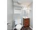 Modern bathroom with wood-style vanity, mirror, and a toilet at 3414 Ferncliff Ave, Indianapolis, IN 46227