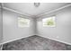 This bedroom features gray walls, neutral carpet, and two windows that let in natural light at 3414 Ferncliff Ave, Indianapolis, IN 46227