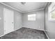 This bedroom features gray walls, neutral carpet, and a window that lets in natural light at 3414 Ferncliff Ave, Indianapolis, IN 46227