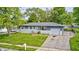 Charming single-story home features a well-maintained front yard, driveway, and beautiful trees at 3414 Ferncliff Ave, Indianapolis, IN 46227