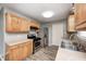 Well-lit kitchen featuring stainless steel appliances, wooden cabinets, and laminate flooring at 3414 Ferncliff Ave, Indianapolis, IN 46227
