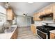 Bright kitchen with wooden cabinets, stainless steel appliances, and views to the dinning area at 3414 Ferncliff Ave, Indianapolis, IN 46227