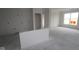 Unfinished Living room of new home with smooth concrete floors, painted walls and one large window at 3599 Hauser Ct, Bargersville, IN 46106