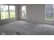 Unfinished Living room of new home with large windows showing the lush yard at 3599 Hauser Ct, Bargersville, IN 46106
